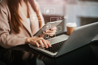 Midsection of woman using laptop