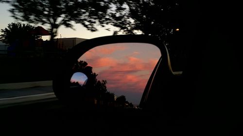 Silhouette trees against sky at sunset