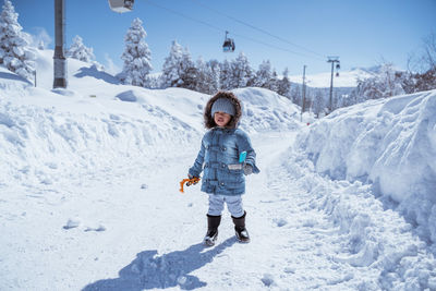 Portrait of woman skiing on snow covered landscape