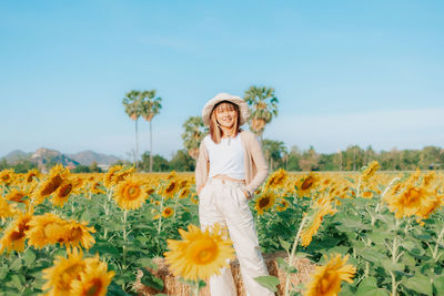 Full length of woman standing on field against sky