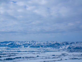 Snow covered landscape against sky