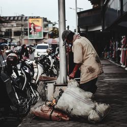 Man working on street in city