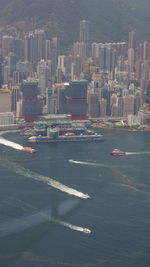 High angle view of city by sea against buildings