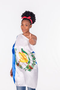 Portrait of smiling young woman against white background