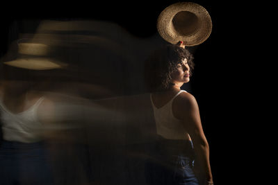 Time-lapse view of woman moving a hat. long exposure, motion blur. happy woman. salvador, brazil.