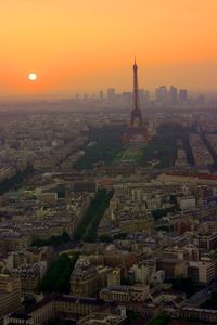 Aerial view of buildings in city during sunset