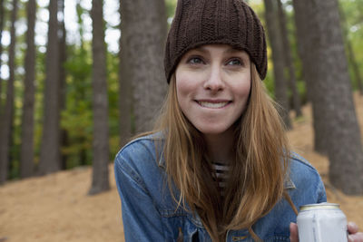 Portrait of smiling young woman in forest