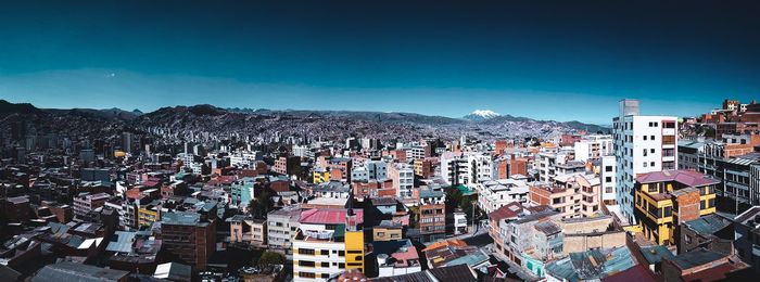 High angle view of townscape against blue sky