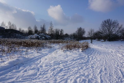 Snow covered field against sky