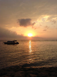 Lone boat in calm sea against scenic sky