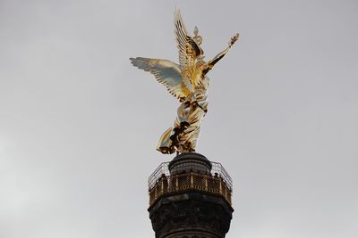 Low angle view of statue of liberty against sky