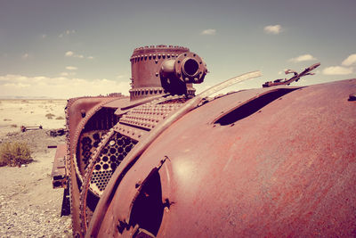 Abandoned truck on beach against sky