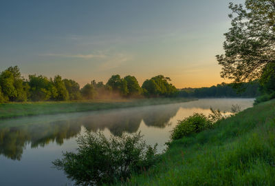 Scenic view of lake against sky during sunset