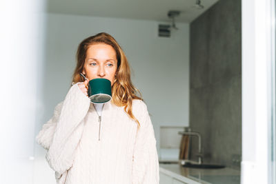Portrait of woman with coffee cup