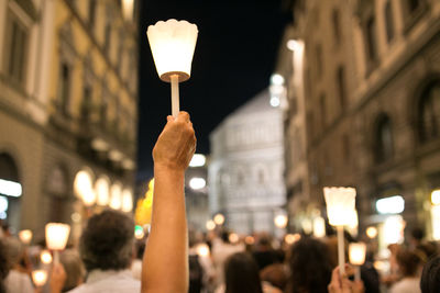 View of person holding candle at night