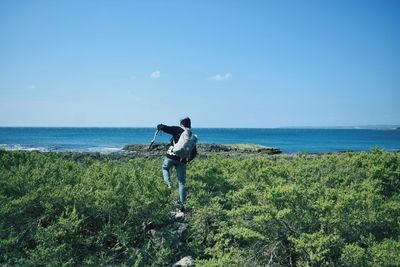 Full length of man on sea shore against sky