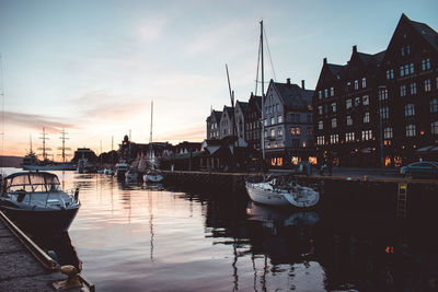 Boats in harbor at sunset