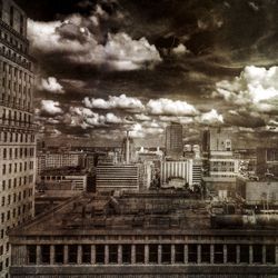 Modern buildings against cloudy sky