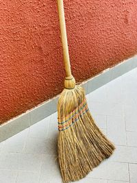 High angle view of broom on floor against wall