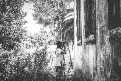 Woman standing on tree trunk