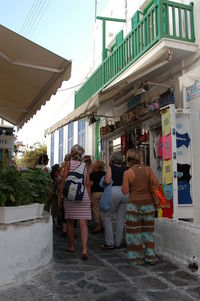 Rear view of people walking on street