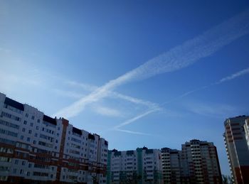 Low angle view of buildings against blue sky