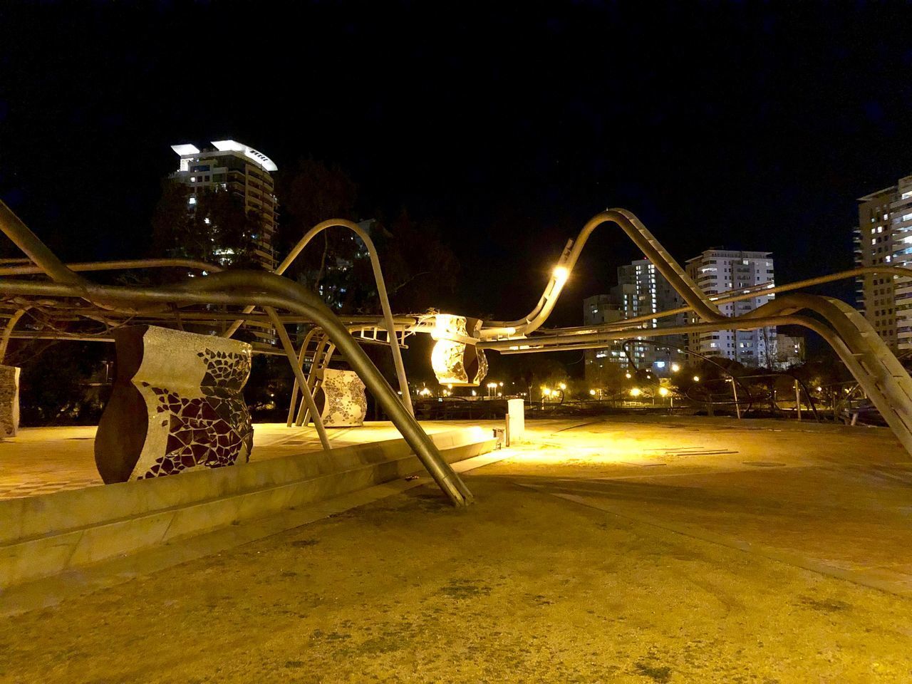 ILLUMINATED BRIDGE AGAINST SKY IN CITY AT NIGHT