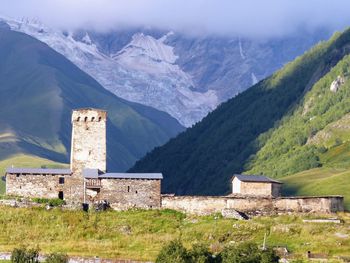 Buildings on mountain range against sky