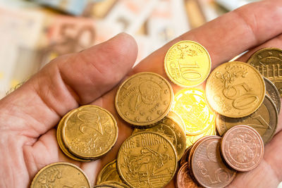 Close-up of hand holding coins