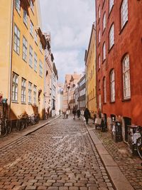 Street amidst buildings in city against sky