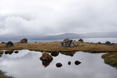 Scenic view of sea against cloudy sky