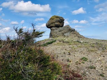 Low angle view of rock formations against sky