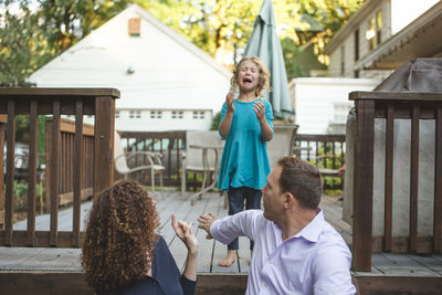 Parents admonish an unhappy crying little girl