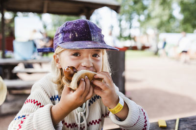 Girl eating hot dog