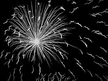 Low angle view of firework display at night