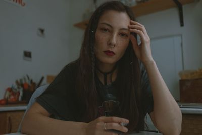 Young beautiful woman with cigarette at home