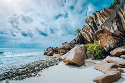 Panoramic view of rocks on beach against sky