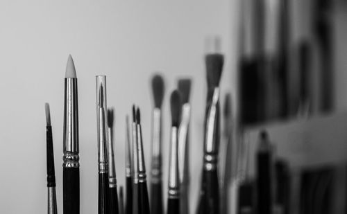 Close up of brushes against a wall