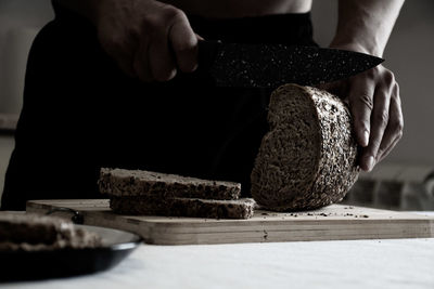 Close-up of man cutting board