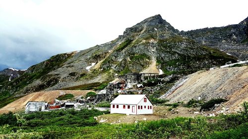 Built structure on landscape against mountain range