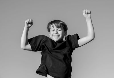 Portrait of boy jumping against white background