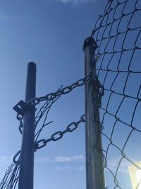 Low angle view of barbed wire against sky