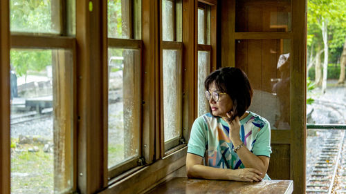 Woman looking through window