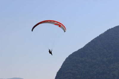 Low angle view of person paragliding