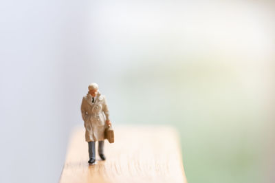 Young woman with toy standing on wood