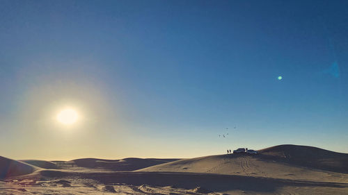 Scenic view of mountains against clear sky during sunset