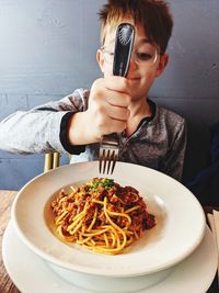 A boy celebrates lunch with his dad during covid 