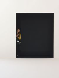 Side view of woman standing against white background