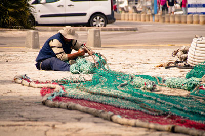 Man repairing fishing net