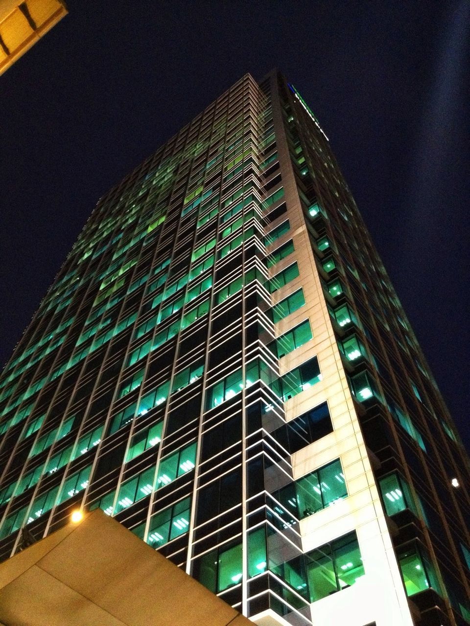 architecture, built structure, building exterior, low angle view, modern, night, city, skyscraper, illuminated, tall - high, office building, tower, building, sky, no people, outdoors, tall, clear sky, capital cities, travel destinations